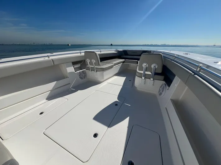 Yacht Photos Pics 2022 Invincible 42 Open Fisherman boat interior with seating, ocean view, and clear sky.
