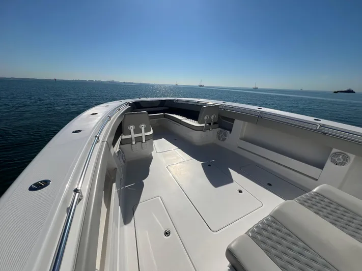  Yacht Photos Pics 2022 Invincible 42 Open Fisherman boat on calm water, sunny day.