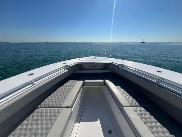  Yacht Photos Pics 2022 Invincible 42 Open Fisherman boat on calm ocean waters under clear blue sky.