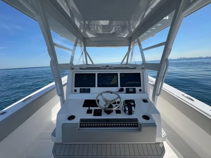  Yacht Photos Pics 2022 Invincible 42 Open Fisherman boat dashboard with ocean view.