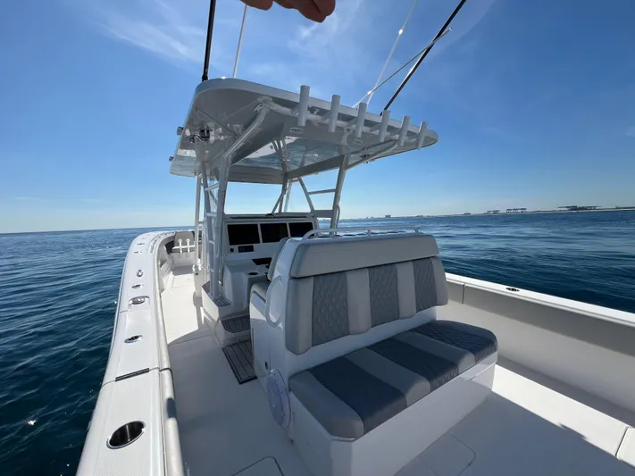  Yacht Photos Pics 2022 Invincible 42 Open Fisherman boat on open water, featuring sleek design and spacious seating.