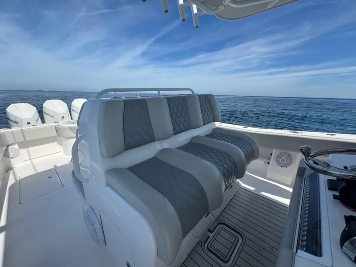  Yacht Photos Pics 2022 Invincible 42 Open Fisherman boat interior with cushioned seating and ocean view.