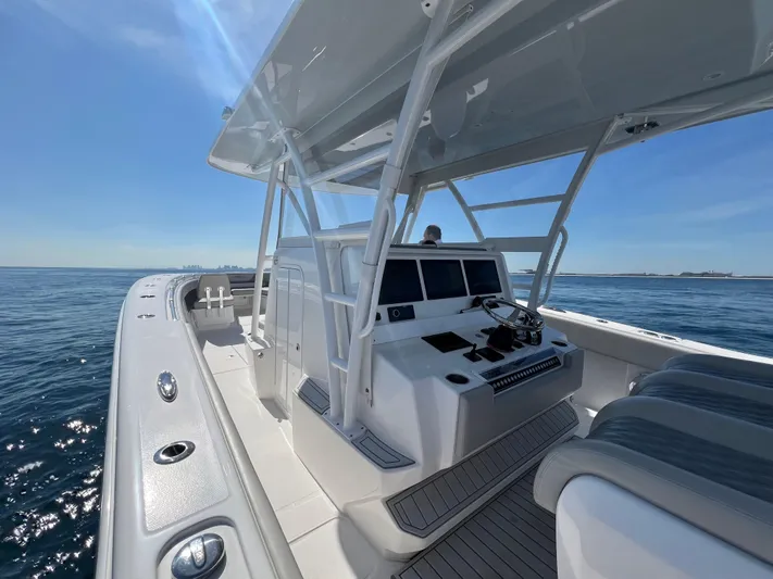  Yacht Photos Pics 2022 Invincible 42 Open Fisherman boat on open water, featuring sleek design and modern controls.