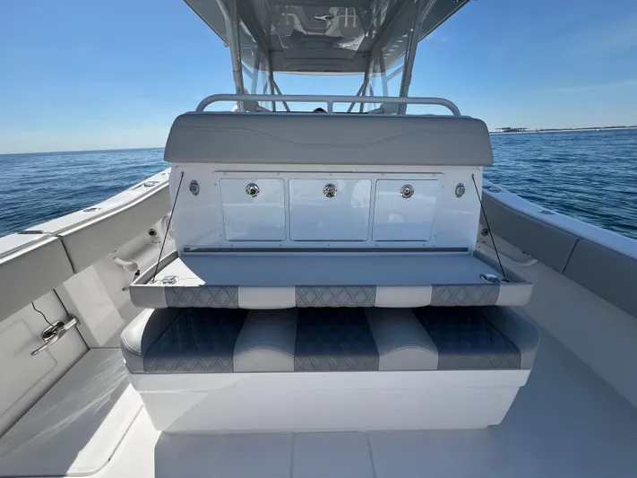  Yacht Photos Pics 2022 Invincible 42 Open Fisherman boat interior with seating and storage on open water.