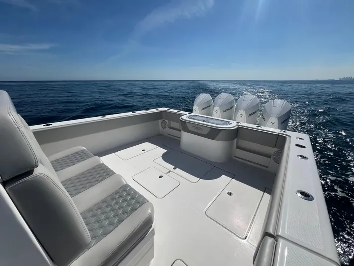  Yacht Photos Pics 2022 Invincible 42 Open Fisherman boat on open sea, featuring spacious deck and multiple engines.
