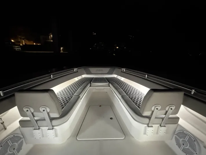  Yacht Photos Pics 2022 Invincible 42 Open Fisherman boat interior with illuminated seating at night.