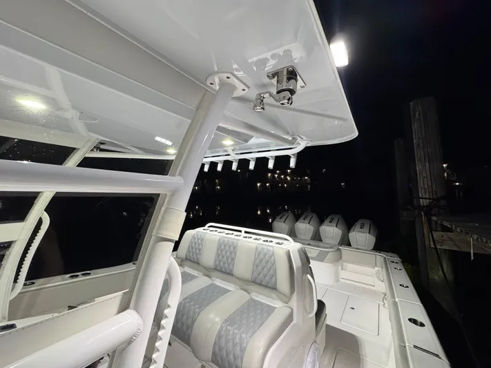  Yacht Photos Pics 2022 Invincible 42 Open Fisherman boat interior at night, featuring seating and multiple engines.
