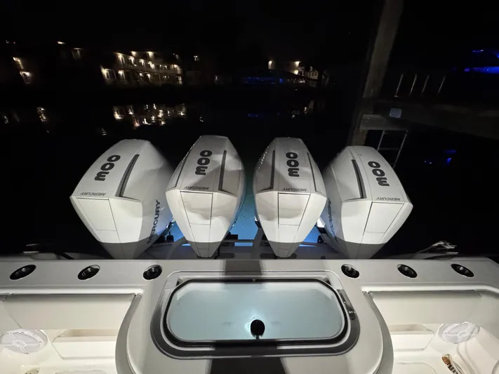  Yacht Photos Pics 2022 Invincible 42 Open Fisherman with quad outboard engines at night.