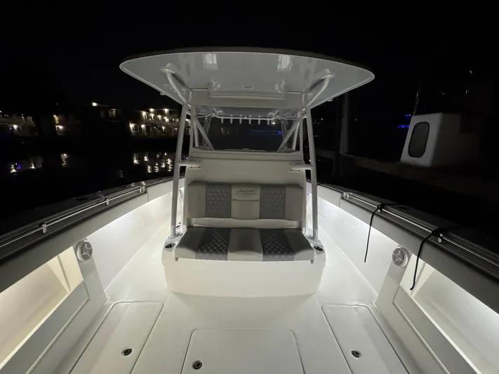  Yacht Photos Pics 2022 Invincible 42 Open Fisherman boat interior at night, featuring illuminated seating and sleek design.