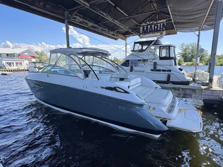  Yacht Photos Pics 2017 Cobalt R35 boat docked under marina canopy on a sunny day.