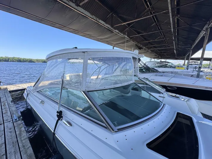  Yacht Photos Pics 2017 Cobalt R35 boat docked under a covered marina, with clear canopy and scenic lake view.