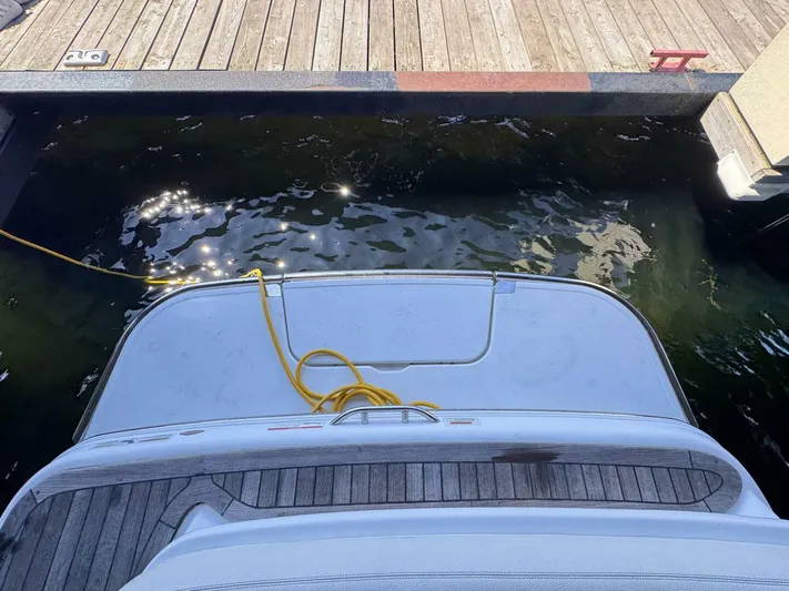 Yacht Photos Pics Rear view of a 2017 Cobalt R35 boat docked, with a yellow rope on the deck.