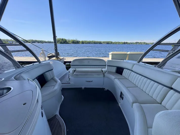  Yacht Photos Pics Luxurious 2017 Cobalt R35 boat interior with white seating, docked by a serene lake.