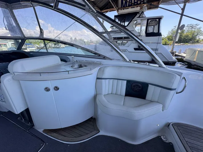  Yacht Photos Pics Interior of a 2017 Cobalt R35 boat with seating and a small sink area.