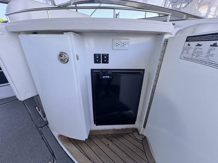  Yacht Photos Pics 2017 Cobalt R35 boat interior with mini fridge and storage cabinet.