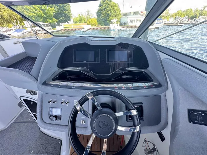  Yacht Photos Pics Steering console of a 2017 Cobalt R35 boat with dual screens and controls.