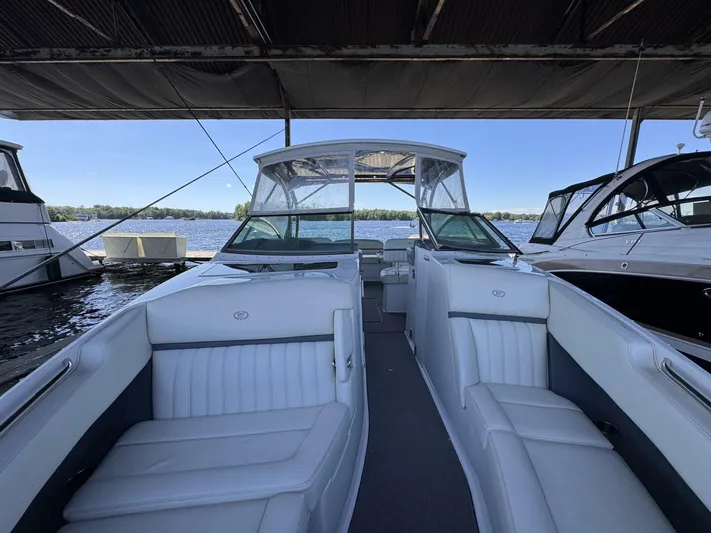 Yacht Photos Pics 2017 Cobalt R35 boat interior with white seating, docked under a canopy.