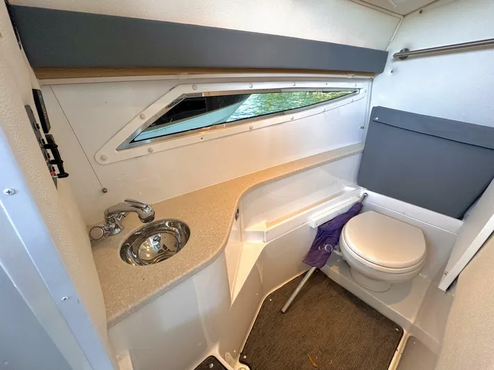  Yacht Photos Pics 2017 Cobalt R35 boat interior with sink and toilet, featuring modern design and compact layout.