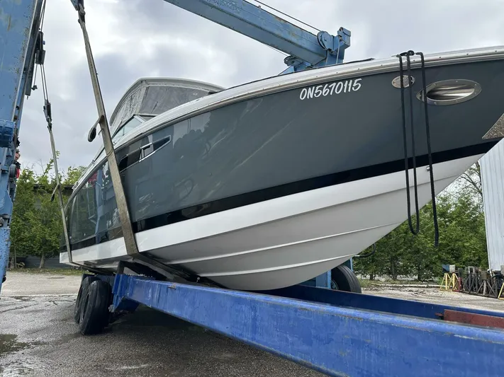  Yacht Photos Pics 2017 Cobalt R35 boat on a lift, showcasing sleek design and hull details.