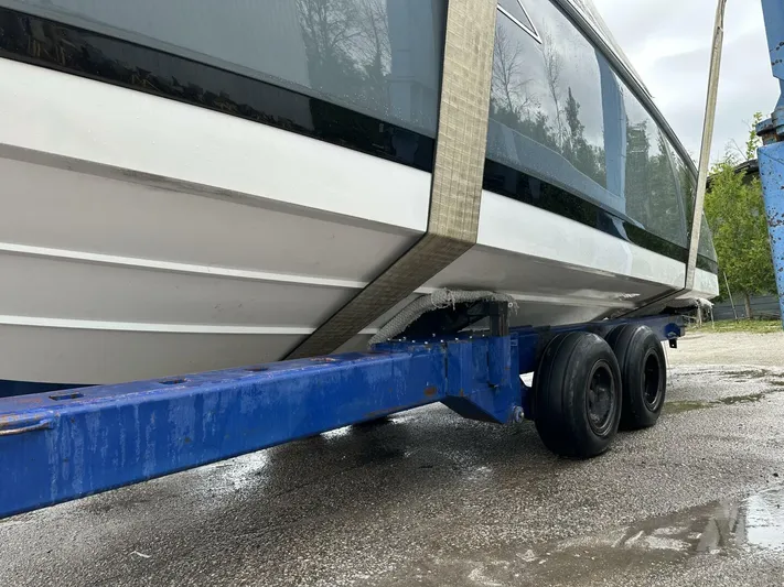  Yacht Photos Pics 2017 Cobalt R35 boat on trailer, secured with straps, ready for transport.