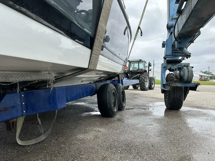  Yacht Photos Pics Boat on trailer with tractor and lift, Cobalt R35, 2017 model, overcast day.
