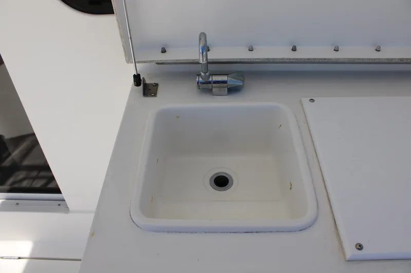Worth The Wake Yacht Photos Pics White sink and faucet on 2006 Silverton 42 Convertible yacht.