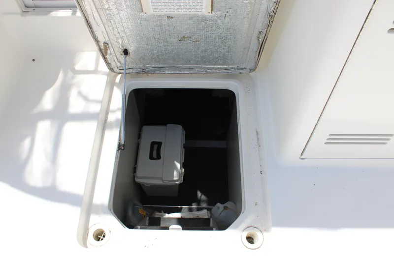 Worth The Wake Yacht Photos Pics Open hatch on 2006 Silverton 42 Convertible boat, revealing storage compartment.