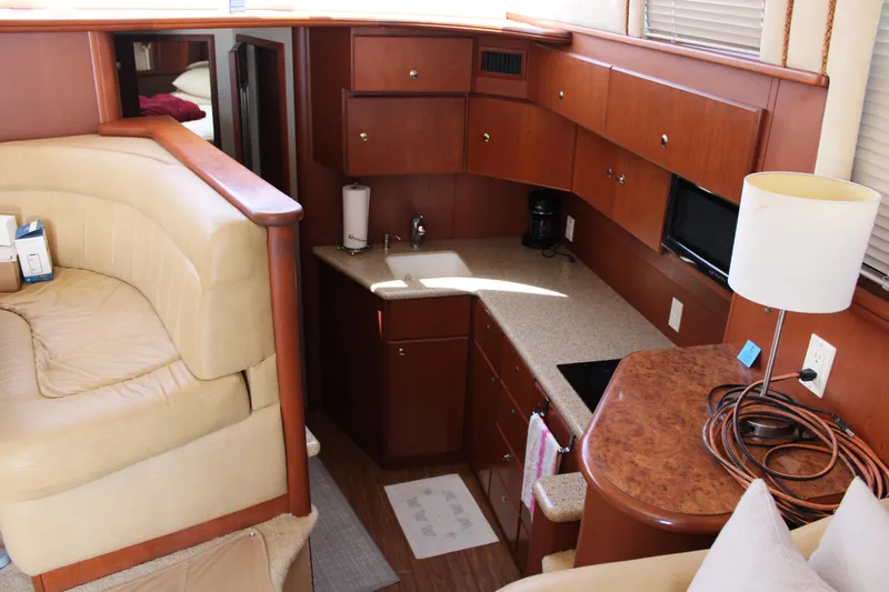 Worth The Wake Yacht Photos Pics 2006 Silverton 42 Convertible yacht interior with kitchen and seating area.