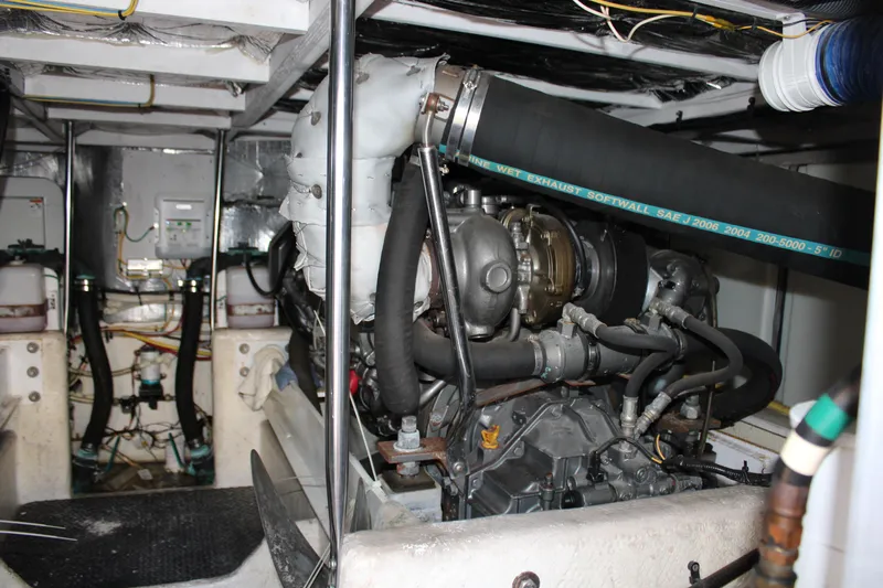 Worth The Wake Yacht Photos Pics Engine room of a 2006 Silverton 42 Convertible yacht, showcasing mechanical components.