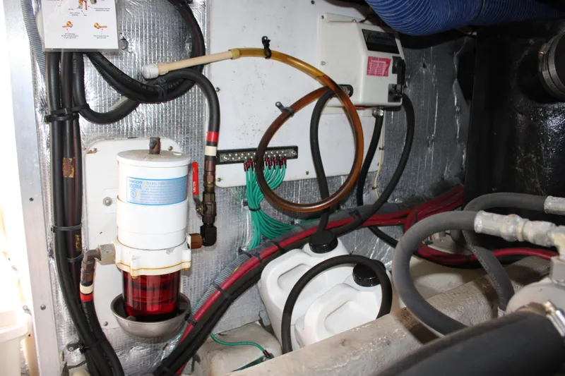 Worth The Wake Yacht Photos Pics Engine room of a 2006 Silverton 42 Convertible with visible fuel filter and wiring.