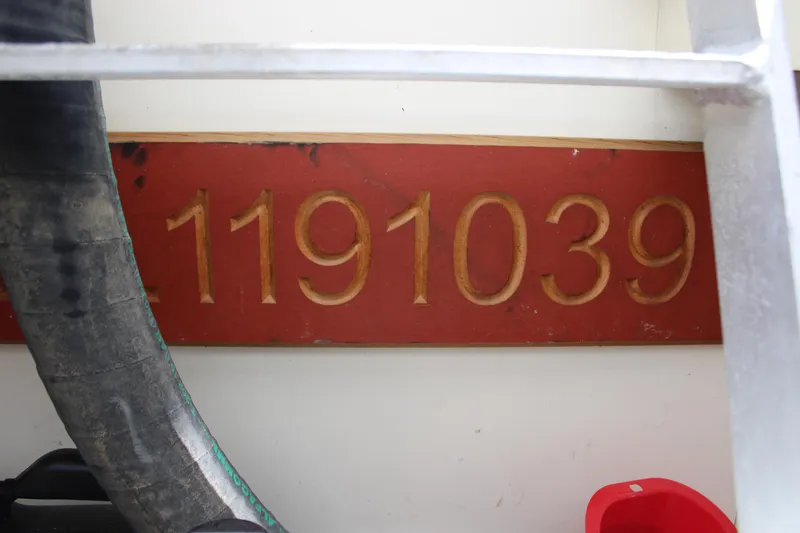 Worth The Wake Yacht Photos Pics Red plaque with gold numbers 1191039 on a 2006 Silverton 42 Convertible boat.