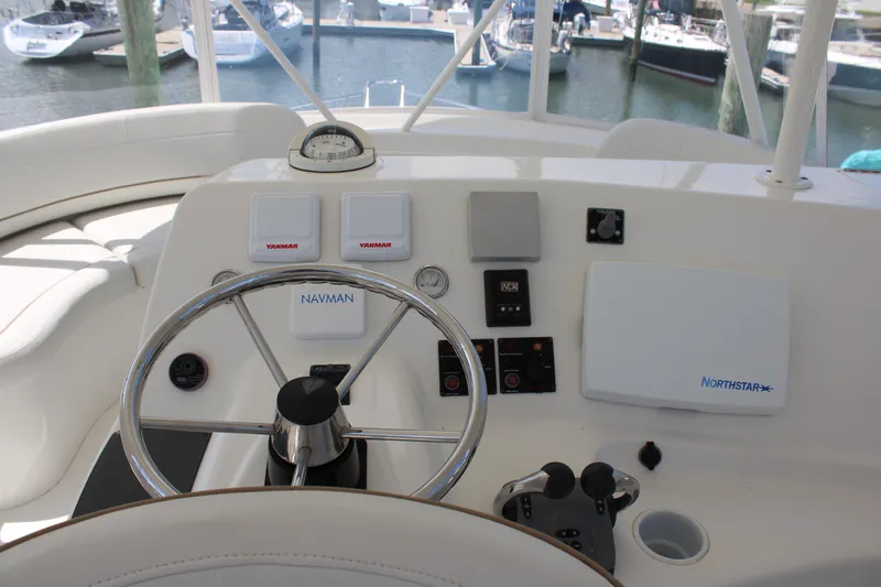 Worth The Wake Yacht Photos Pics 2006 Silverton 42 Convertible yacht helm with steering wheel and navigation controls.