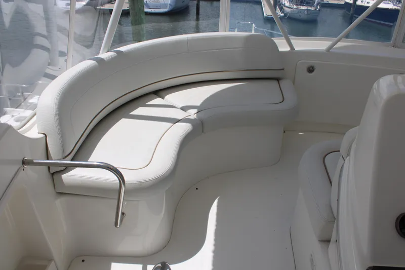 Worth The Wake Yacht Photos Pics 2006 Silverton 42 Convertible yacht with white curved seating on deck.