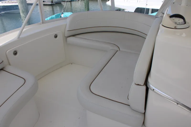 Worth The Wake Yacht Photos Pics 2006 Silverton 42 Convertible boat interior with white cushioned seating.