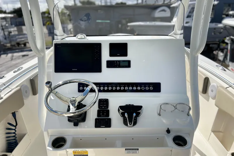  Yacht Photos Pics 2023 Key West 263 FS boat dashboard with steering wheel and electronic controls.