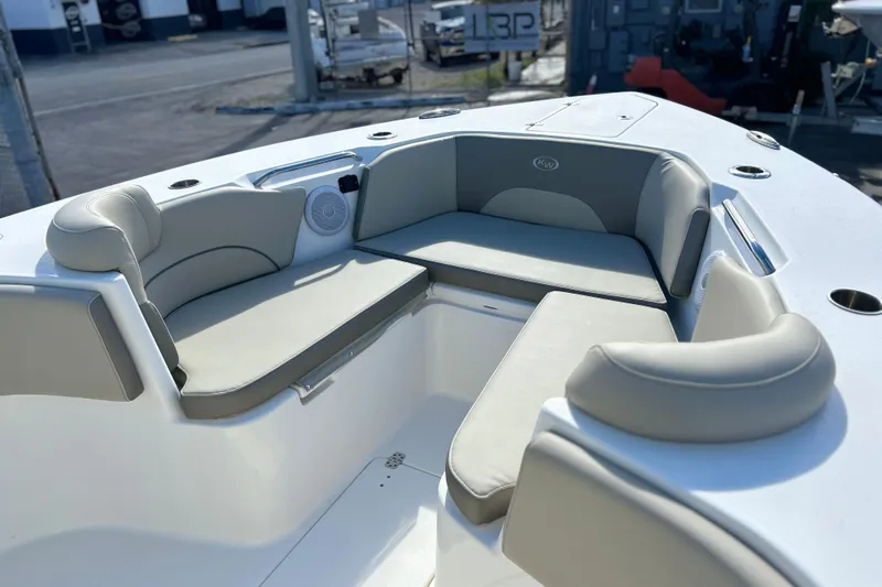  Yacht Photos Pics 2023 Key West 263 FS boat interior with cushioned seating and cup holders.