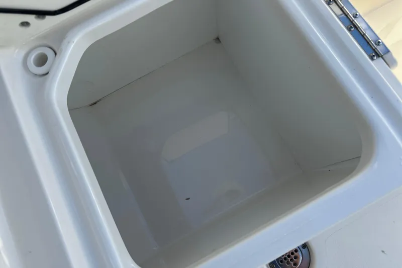  Yacht Photos Pics 2023 Key West 263 FS boat storage compartment, white interior, open lid.