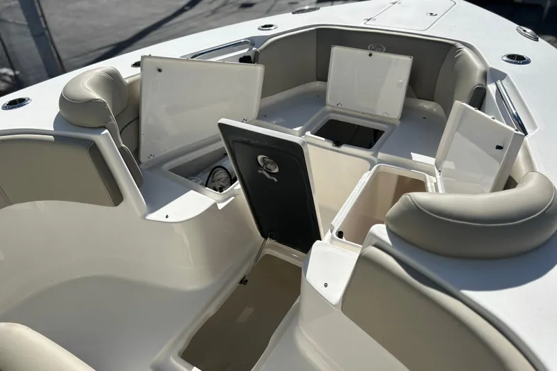  Yacht Photos Pics 2023 Key West 263 FS boat interior with open storage compartments and cushioned seating.