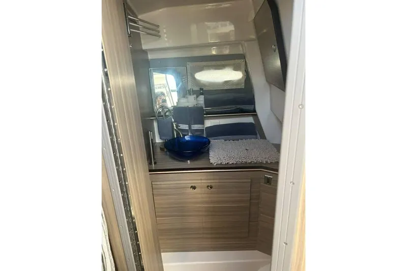 Venessa 1968 - Brokerage Kevin Yacht Photos Pics 2026 Solara S-310 SB interior bathroom with modern sink and wooden cabinetry.