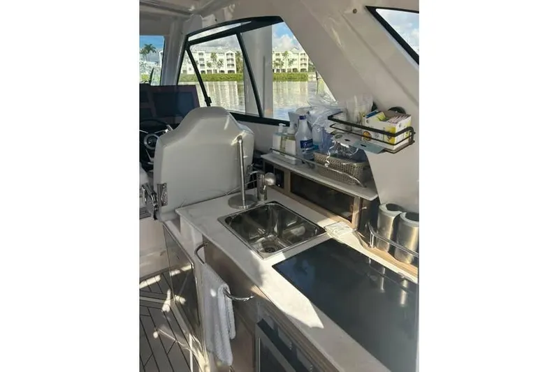Venessa 1968 - Brokerage Kevin Yacht Photos Pics Interior of 2026 Solara S-310 SB boat with modern kitchenette and scenic view.