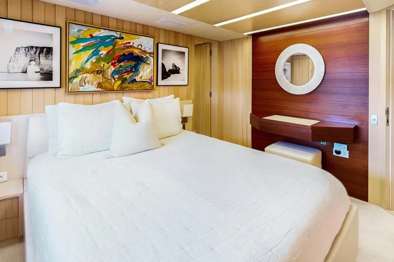 Dylan Anne Yacht Photos Pics Luxurious bedroom interior on 2015 Benetti Traditional Supreme 108 yacht, featuring elegant decor and artwork.