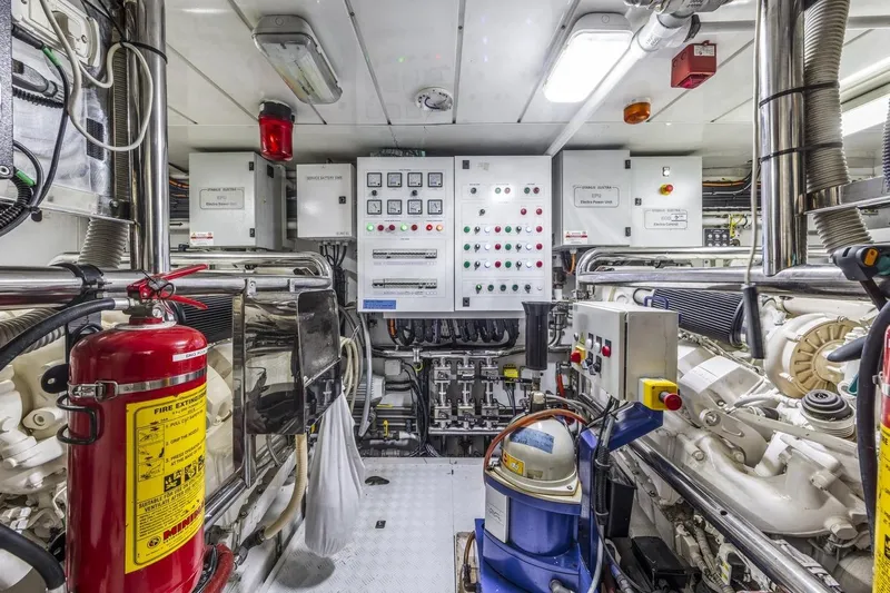 Dylan Anne Yacht Photos Pics Engine room of 2015 Benetti Traditional Supreme 108 yacht, featuring control panels and fire extinguisher.
