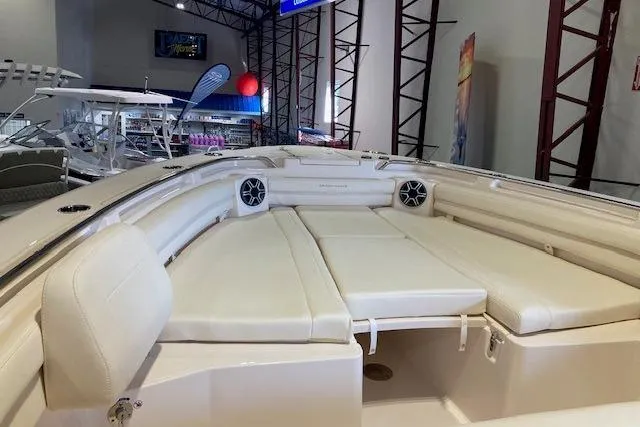  Yacht Photos Pics 2026 Grady-White Canyon 336 boat interior with cushioned seating and speakers in showroom.