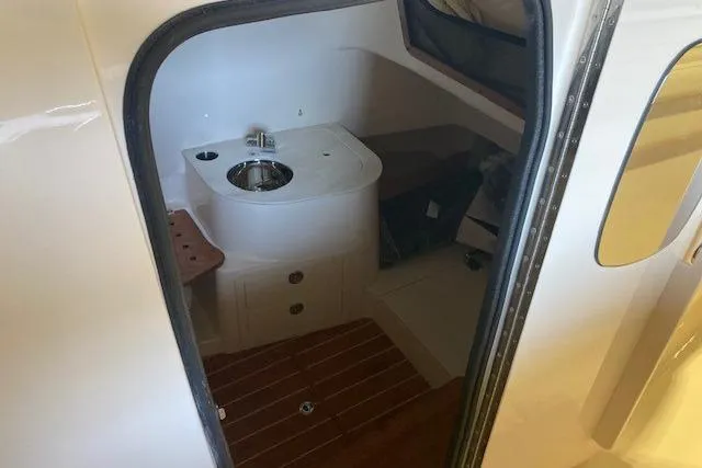  Yacht Photos Pics Interior of 2026 Grady-White Canyon 336 boat, featuring compact sink and wooden flooring.