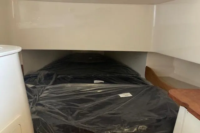  Yacht Photos Pics 2026 Grady-White Canyon 336 cabin interior with covered bedding.