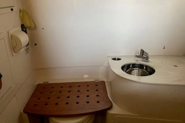  Yacht Photos Pics 2026 Grady-White Canyon 336 boat bathroom with sink and wooden seat cover.