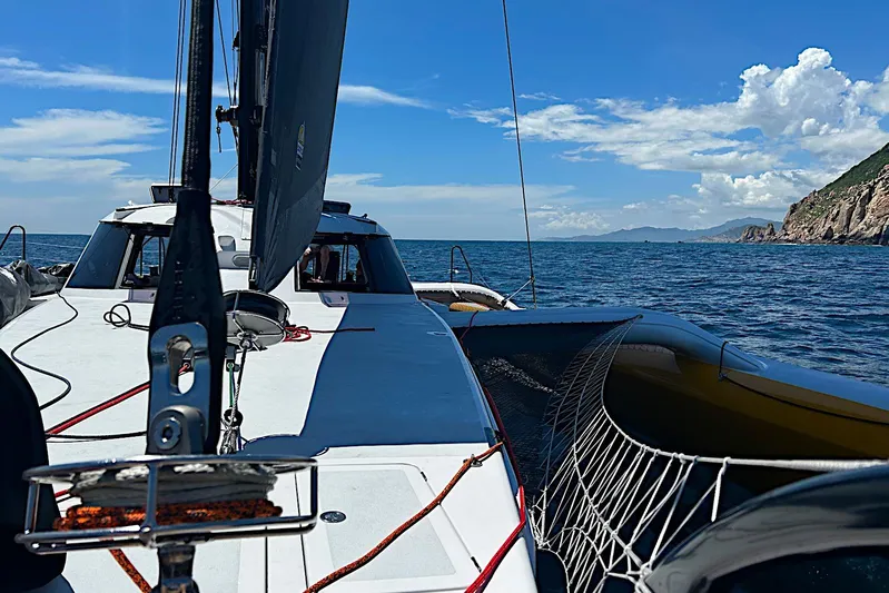  Yacht Photos Pics Sailing on a 2026 Rapido 60 trimaran with scenic ocean and coastal views.