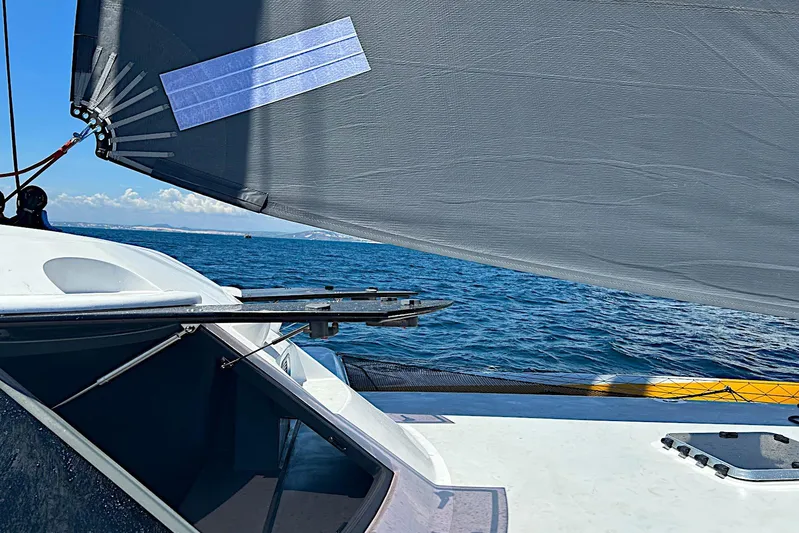 Yacht Photos Pics Sailing on a 2026 Rapido 60 trimaran with a view of the ocean and sail.