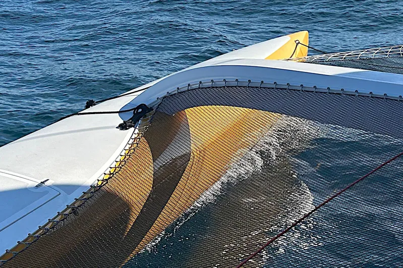  Yacht Photos Pics Rapido 60 trimaran sailing on water, showcasing netting and hull design, 2026 model.