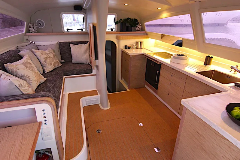  Yacht Photos Pics Luxurious interior of 2026 Rapido 60 yacht with modern kitchen and cozy seating area.